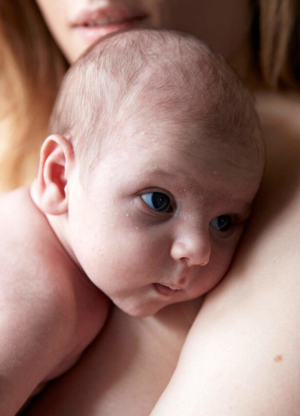 Newborn skin touching mother's skin 